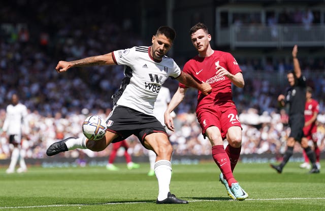 Aleksandar Mitrovic, left, holds off Liverpool's Andy Robertson