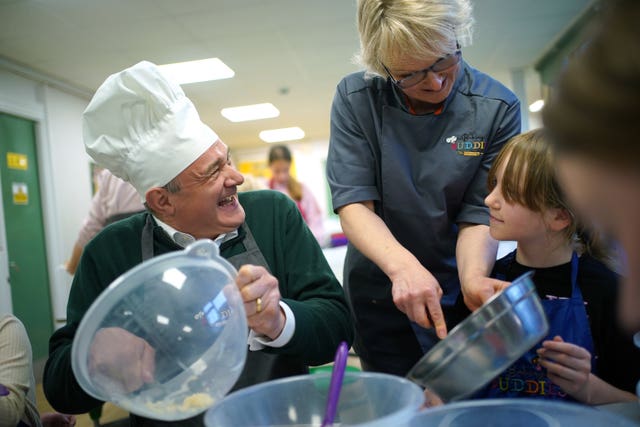 Liberal Democrats leader Sir Ed Davey taking part in a baking lesson with primary school students