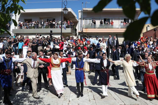 They had a dance during a tour of stalls showcasing Cretan produce, crafts, local initiatives and entrepreneurs (Andrew Matthews/PA)