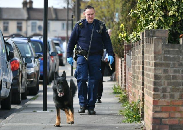 A police officer and police dog on Aberdeen Road in north London