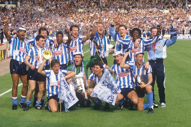 Regis, back left, celebrated the famous win with his team-mates on the hallowed Wembley turf 