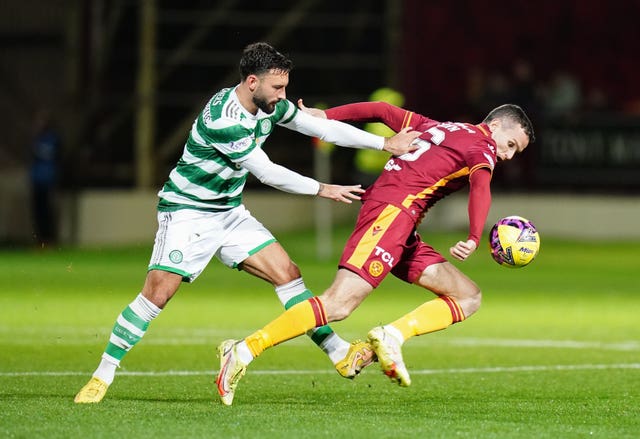 Celtic’s Sead Haksabanovic and Motherwell’s Paul McGinn battle for the ball during the Premier Sports Cup quarter final at Fir Park, Motherwell on Wednesday