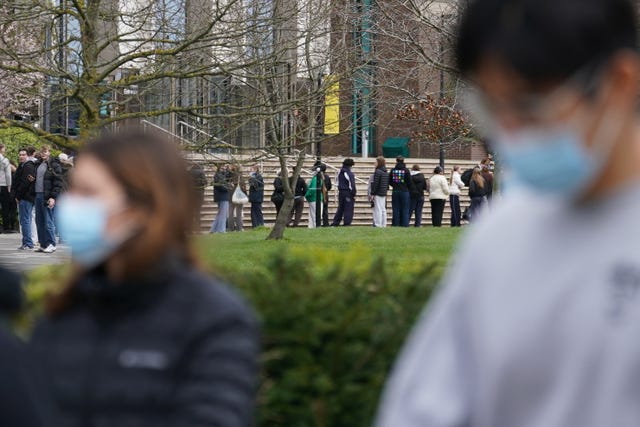 Students queuing for antibiotics outside a building at the University of Kent in Canterbury