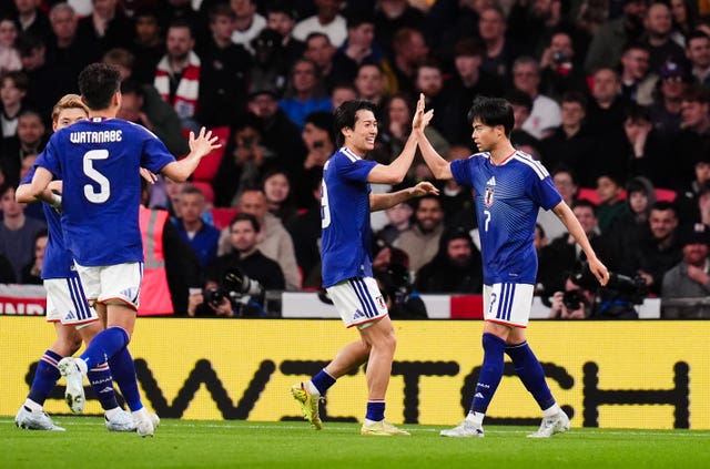 Japan’s Kaoru Mitoma, right, celebrates his goal against England