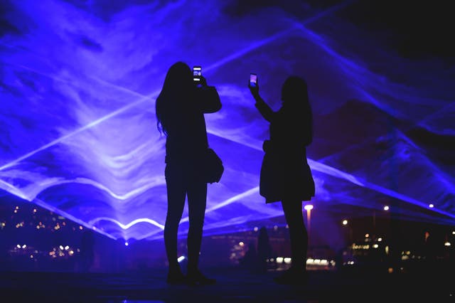 People look at Waterlicht by Daan Roosegaarde at Granary Square (Kirsty O’Connor/PA)