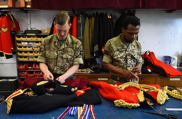 Members of the Household Calvary at work in the Tailors Shop at Hyde Park Barracks, Knightsbridge, London, ahead of the royal wedding (Kirsty O’Connor/PA)