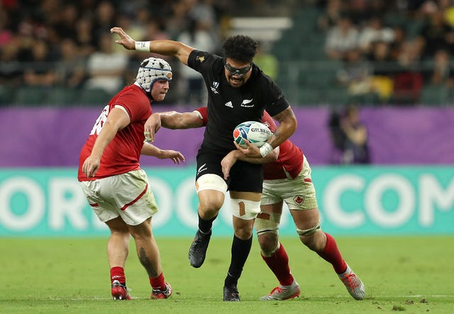 Ardie Savea breaks a tackle from Canada's Lucas Rumball, right