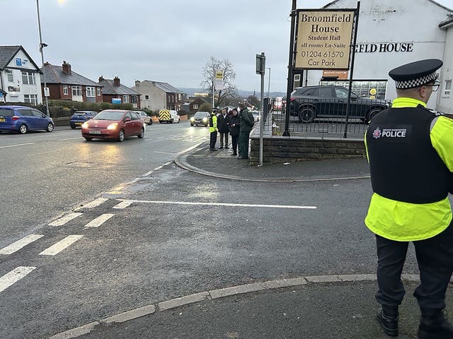 A police officer standing at a junction near where the crash took place