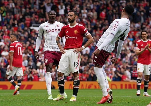 Manchester United's Bruno Fernandes (centre) reacts to his missed penalty against Aston Villa