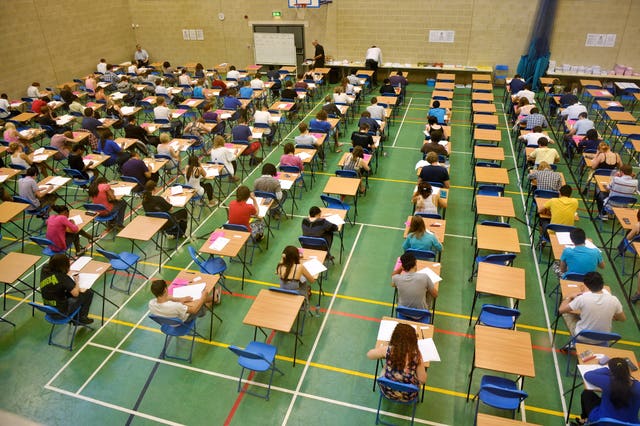 A-level students sitting an exam inside a sports hall