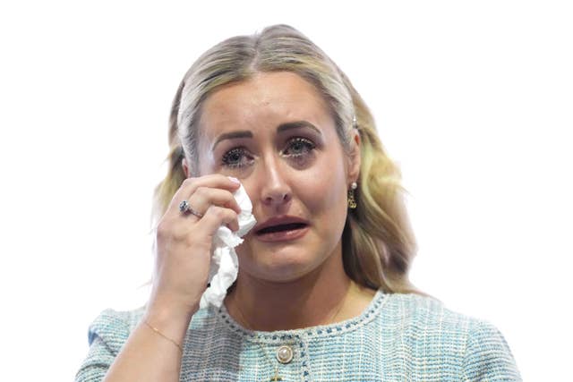 Katie Amess using a tissue to wipe tears from her eyes