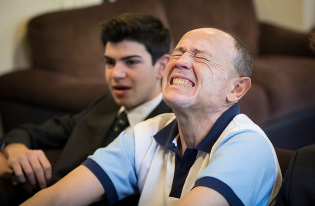 Pupil Alejandro and tennis coach Trevor Loten watch Kyle Edmund taking on Marin Cilic on a TV at Fenwick-Smith House, a senior boarding house at at Pocklington Prep School, Beverley (Danny Lawson/PA)