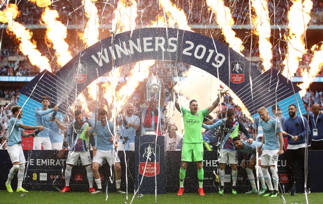 Manchester City skipper Vincent Kompany (centre) lifts the FA Cup after a 60 final victory over Watford