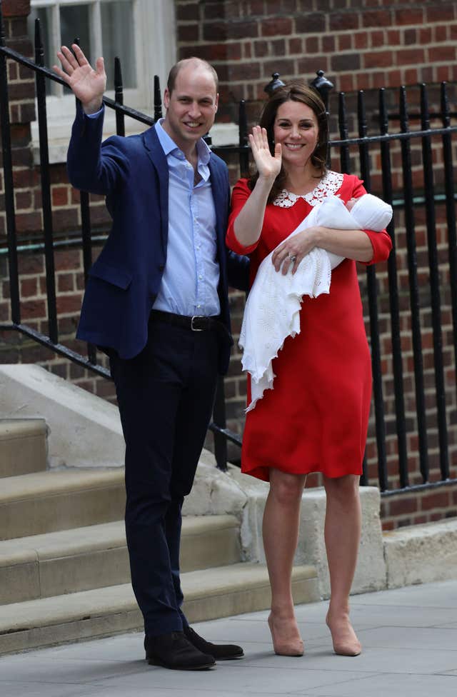 William and Kate, in her patriotic dress, and the new baby prince (Aaron Chown/PA)