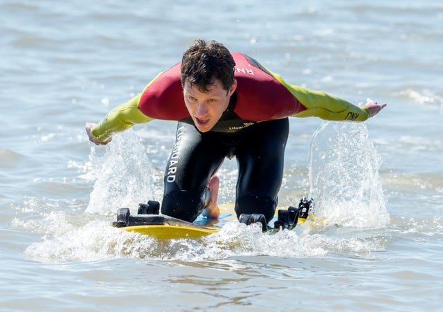 An RNLI Lifeguard takes to the water in Bridlington, East Yorkshire