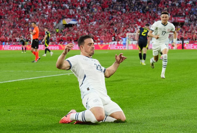 Xherdan Shaqiri slides on his knees as he celebrates his equaliser for Switzerland