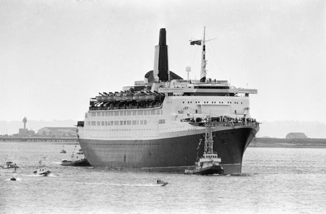 The QE2 coming into dock at Southampton after her voyage from the Falklands (PA)