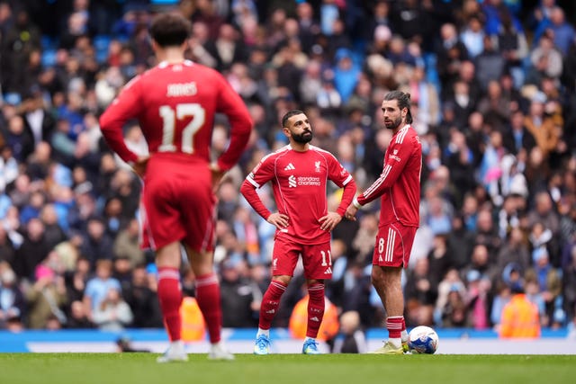 Liverpool players look dejected during their loss to Manchester City