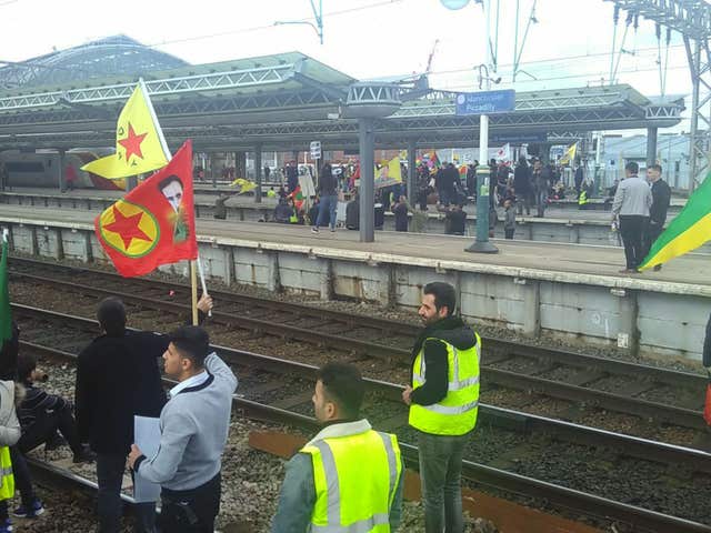 Protesters against Turkish war on Syrian Kurds block the tracks at Manchester Piccadilly station bringing rail services in and out of the terminal to a halt. (PA Wire / Sophy Colbert)