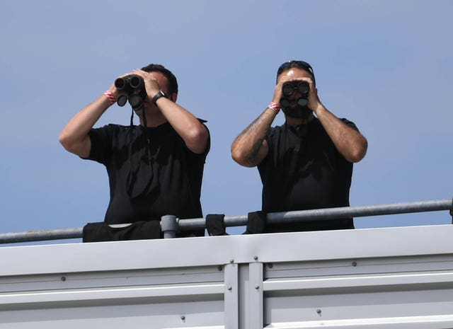 Security officers wait for the president's arrival at Stansted