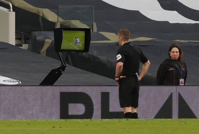 Referee Craig Pawson checks the pitchside monitor