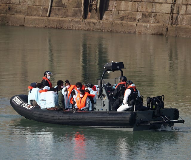 A group of people, thought to be migrants, are ferried ashore by Border Force officers at Dover marina in Kent