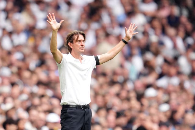 Tottenham manager Thomas Frank holds his hands up on the touchline