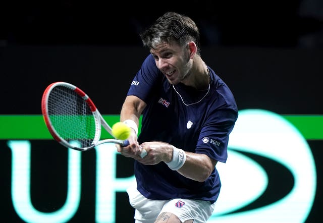 Cameron Norrie strikes a backhand against Novak Djokovic