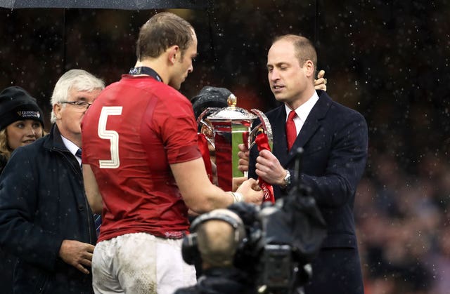 Wales' Alun Wyn Jones is presented with the trophy 