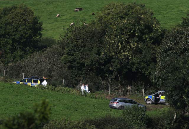 Police and forensics officers at farmland in Killen, around a mile from Castlederg (Brian Lawless/PA)