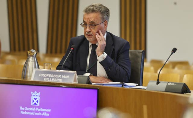 Professor Iain Gillespie seated in a Holyrood committee meeting