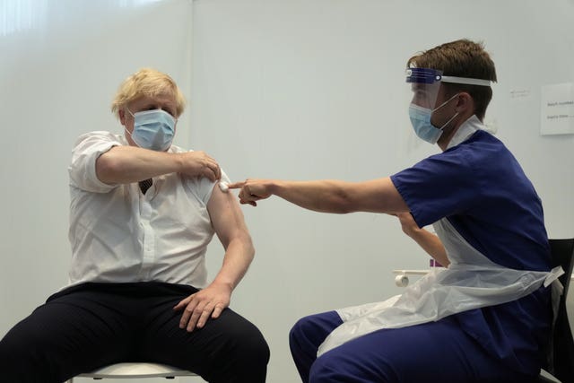 Prime Minister Boris Johnson receives his second jab of the AstraZeneca coronavirus vaccine from James Black, at the Francis Crick Institute in London (Matt Dunham/PA)