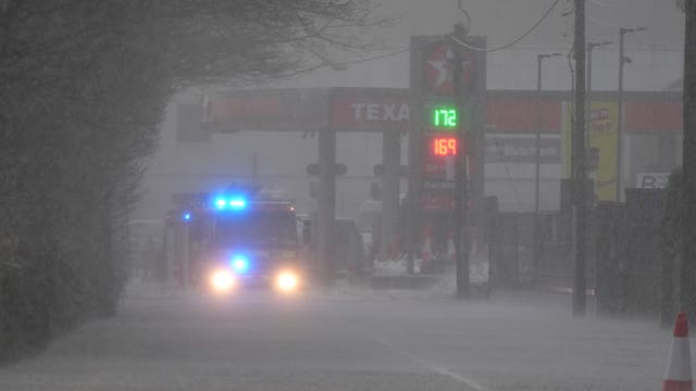 A fire engine responding to an emergency during the treacherous weather conditons