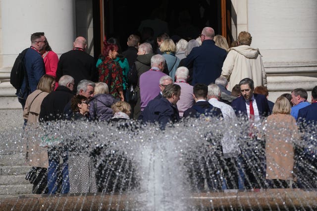 Taoiseach Simon Harris (red tie bottom right) welcomes the families to Government Buildings in Dublin
