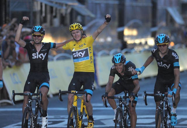 Froome celebrates with Team Sky teammates as he crossed the line to win his first Tour de France in 2013