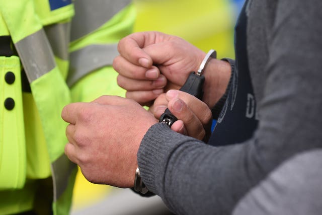A man being placed in handcuffs