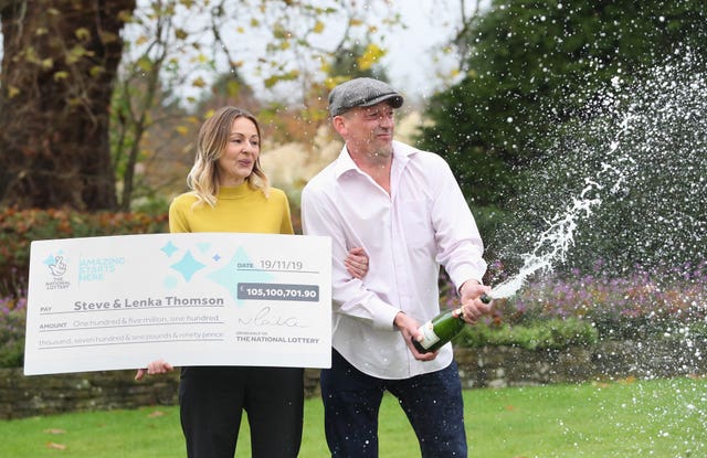 Self-employed builder Steve Thomson, 42, and his wife Lenka Thomson, 41, celebrate their £105 million EuroMillions win (Andrew Matthews/PA)