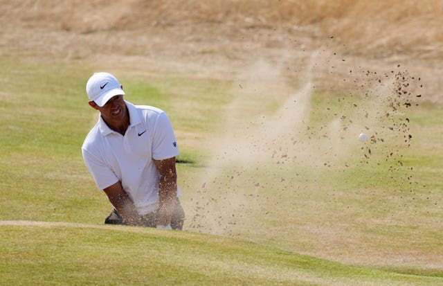 Rory McIlroy of Northern Ireland chips out of a bunker