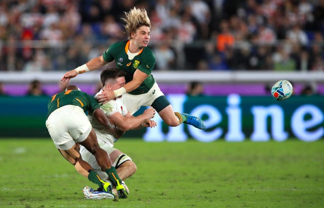 Tom Curry is flattened by South Africa's Faf de Klerk in the final