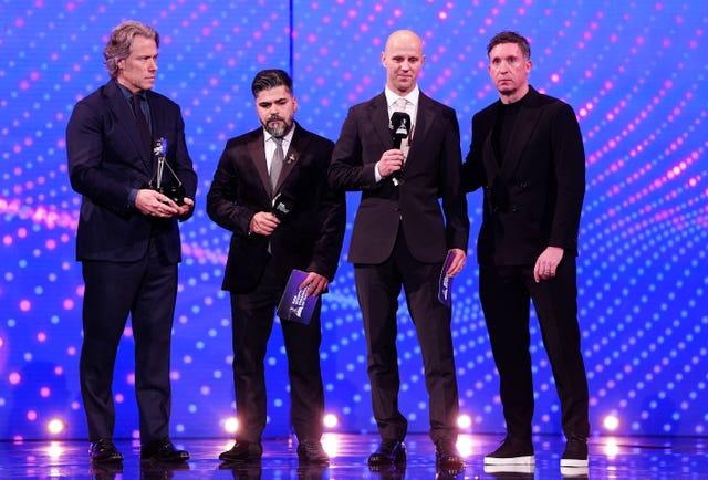 Sergio Aguiar and David Stancombe are presented with the BBC Sports Personality of the Year Helen Rollason Award by John Bishop and Robbie Fowler
