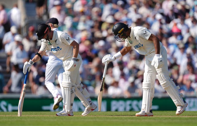 New Zealand’s Henry Nicholls, left, and Rachin Ravindra both prod the wicket with their bats