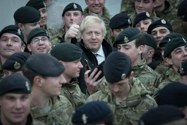 Prime Minister Boris Johnson addresses British soldiers after serving Christmas lunch to British troops stationed in Estonia during a one-day visit to the Baltic country (Stefan Rousseau/PA)