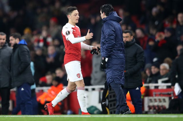 Mesut Ozil, left, has struggled to establish himself under Unai Emery