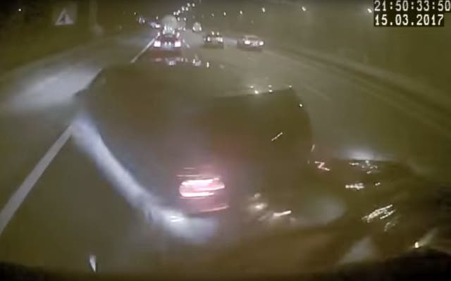 This is the blurred moment the lorry makes contact with the back of a car (West Midlands Police/PA)