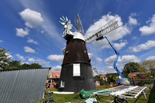 Clamps are adjusted after the new sail is fixed into place (Joe Giddens/PA)