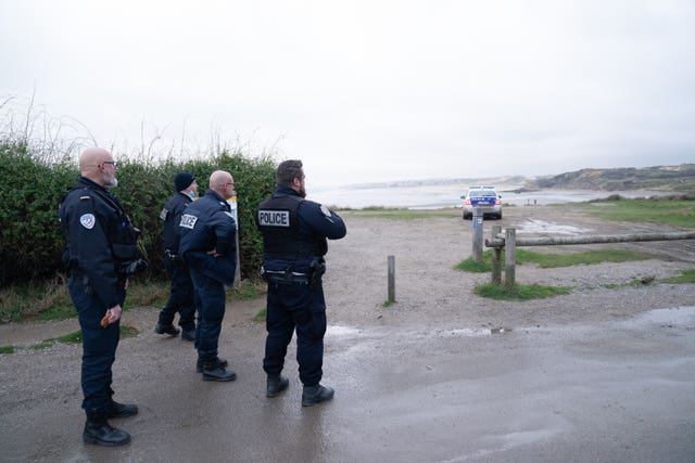 French police look out over a beach near Wimereux believed to be used by migrants trying to get to the UK