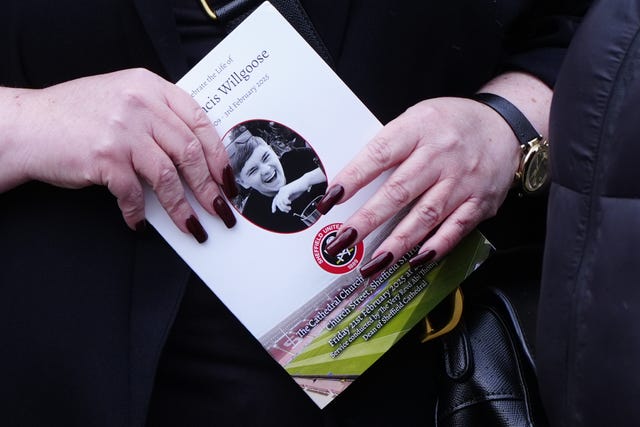 An order of service for the funeral of Harvey Willgoose being held in a woman's hands