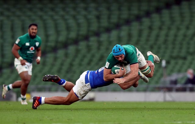 Tadhg Beirne, right, is tackled by Gianmarco Lucchesi