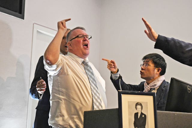 Protester Graham Moore gesturing on stage