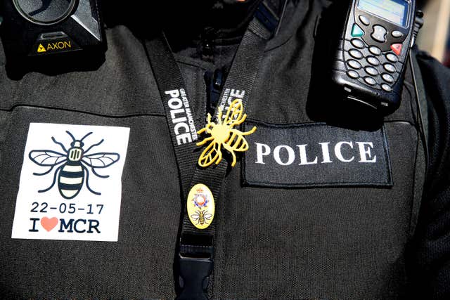 A police officer wears stickers and a bee badge (Peter Byrne/PA)